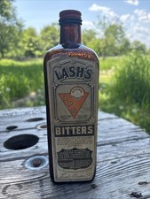 Antique Lash’s Bitters Bottle. Embossed, Labeled, Screw Top. Brown Glass. EMPTY picture