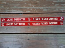 TWO VINTAGE NOS METAL PAINTED SHELF STRIP SIGN LUCKIES LUCKY STRIKE CIGARETTES picture