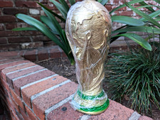 Mixed Lot: White Keyboard, T-Shirts, Soccer Cup, Gold Trophy Decor picture