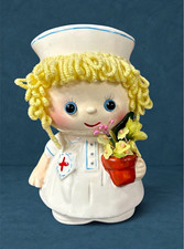Vintage 1985 Enesco Nurse Figurine Ceramic Coin Bank Yellow Yarn Hair Flowers picture