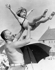 Shirley Temple screen sensation is shown being tossed air by fathe- Old Photo picture