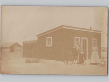 c1910 Family Posing Outside Homestead Cabin & Shed RPPC Real Photo Postcard picture