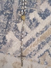 image shows a vintage or antique Catholic rosary featuring clear or givré glass picture