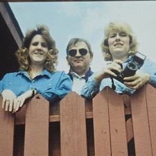 Vintage Photo Snapshot of People Looking Over Wood Fence w/ Camera in Hands picture