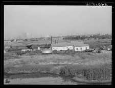 Independent refinery. Business section of Oklahoma City, Oklahoma in background picture