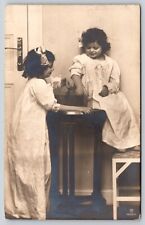 Postcard RPPC Girls Holding Fish in Fish Tank Real Photo Sisters Pet Fish picture