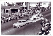 Street Scene Parade with 1950 Oldsmobile Pulling Float Photo picture