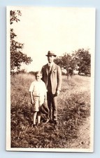 Old Vintage Photo MAN AND BOY WITH HAT STANDING IN FIELD SNAPSHOT PICTURE picture
