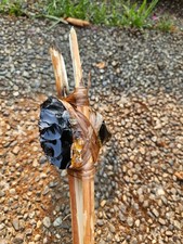 about 4inch obsidian axe with a handle that is about 2 feet picture
