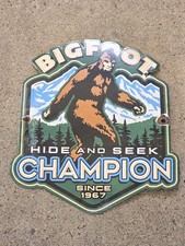 VINTAGE BIGFOOT CHAMPION SPARK PLUGS PORCELAIN SIGN 'HIDE AND SEEK' 10
