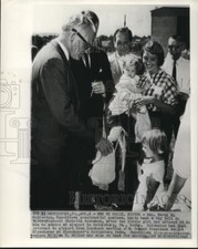 1964 Press Photo Sen. Goldwater hand rag doll back to Christia at airport picture