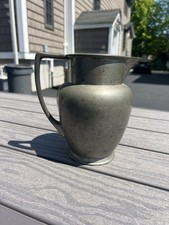 Vintage Reed & Barton pewter pitcher featuring a distinctive engraved monogram picture