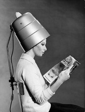 Young woman reading a magazine sitting a chair a back To this a su- Old Photo picture