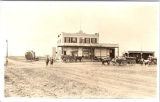 RPPC, Street Scene MCCORMICK'S HAY/FEED STORE Horses/Wagons ca1910's Postcard picture