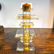 The image shows a vintage Art Deco-style stacked clear and amber Lucite/ perfume picture