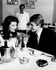 Two models seated restaurant smiling each other drinking a toast 1- Old Photo picture