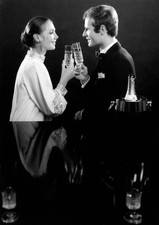 Two models smiling at each other and drinking a toast 1960s Old Photo picture
