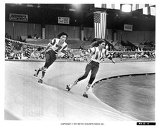 Helena Kallianiotes skates alongside Raquel Welch in a scene from - Old Photo picture