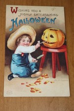 Antique Clapsaddle Halloween Postcard with boy carving a pumplin,  picture