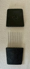 This item is a vintage Goody travel hair pick featuring a protective slipcover. picture