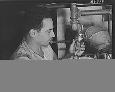 Photo:Fuel Conservation 1940s Man Inspecting Oil Pipe and Valve picture