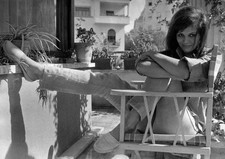 The Italian actress Claudia Cardinale sitting a chair relaxing a r- Old Photo picture