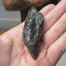 Possible Meteorite . has alot of shiny crystal like flakes BLACK. heavy/HARD picture