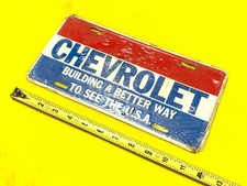 NOS Vintage CHEVROLET License Plate BUILDING A BETTER WAY TO SEE THE U.S.A. picture