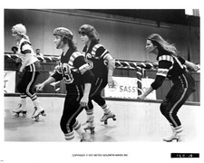 Raquel Welch takes a spin around the rink with her team mates in a- Old Photo picture