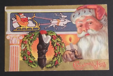 Christmas Joys Santa Sleigh Candle Wreath Stocking Gold Embossed Postcard c1910s picture