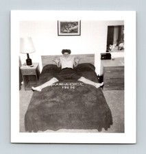 Par-A-Dice Inn Motel Interior View Woman Staddling Logo on Beadspread Cora Lue picture